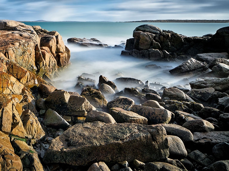 A sunlit seascape and of Roundstone Beach in Connemara