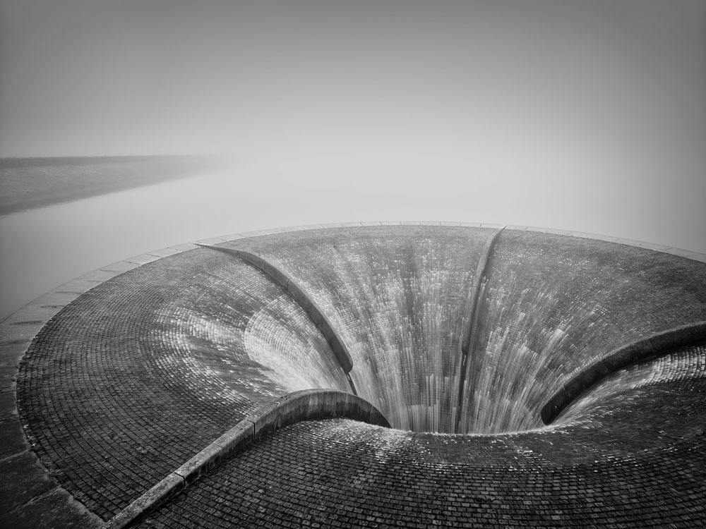 A black and white image of the overflow at Silent Valley Reservoir