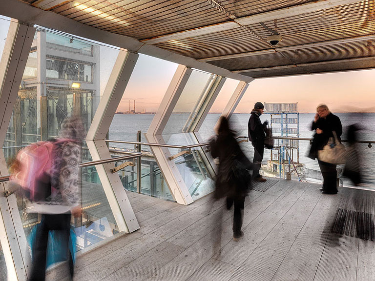 View from Blackrock Dart Station towards the ghostly outline of Blackrock Baths and Dublin Bay