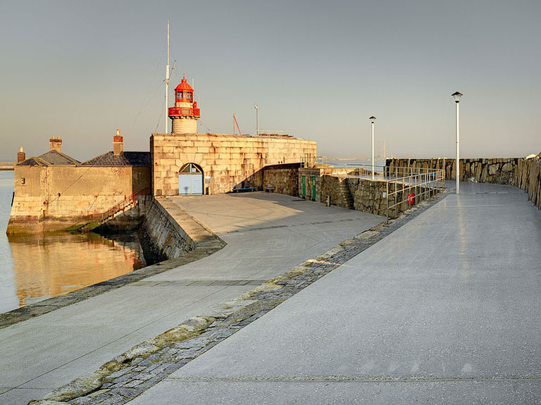 Dun Laoghaire East Pier curving out into calm Dublin Bay on a quiet summer evening