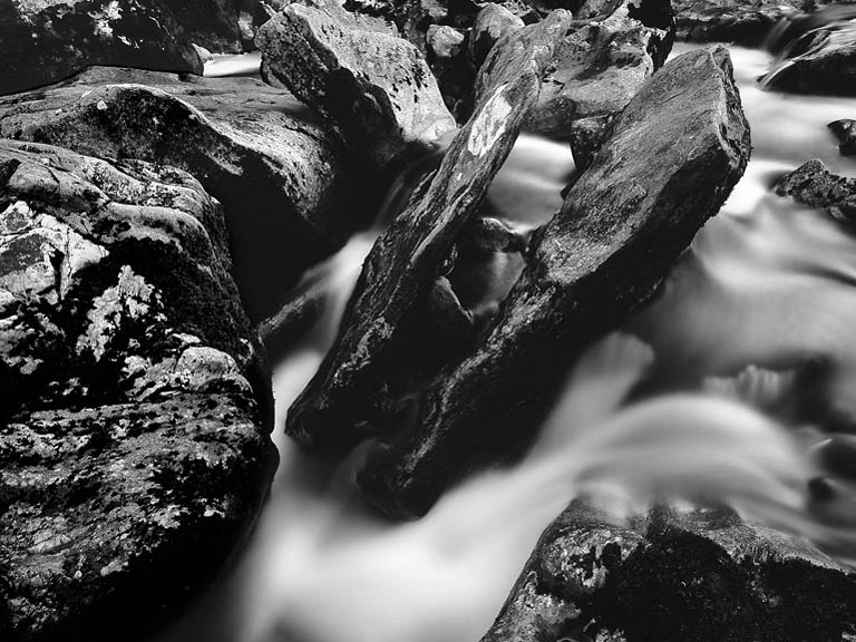 Fine art photograph of the river and valley at Ladies Brae in the Ox Mountains in County Sligo, with reeds, rocks and distant hills.