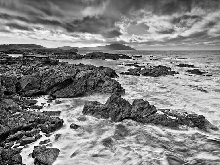 Fine art photograph of the Atlantic Drive on Achill Island in County Mayo, with road, cliffs, sea and distant headlands.