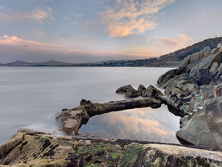 Fine art photograph of the Vico Baths and rocky coastline at Dalkey in Dublin with Dublin Bay beyond
