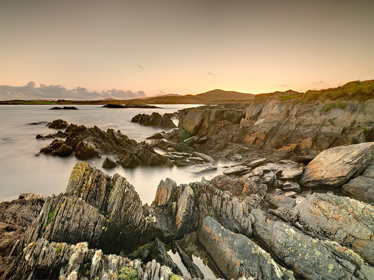 Sunset seascape over Toormoore Bay on the Mizen Peninsula in County Cork with layered headlands and calm sea