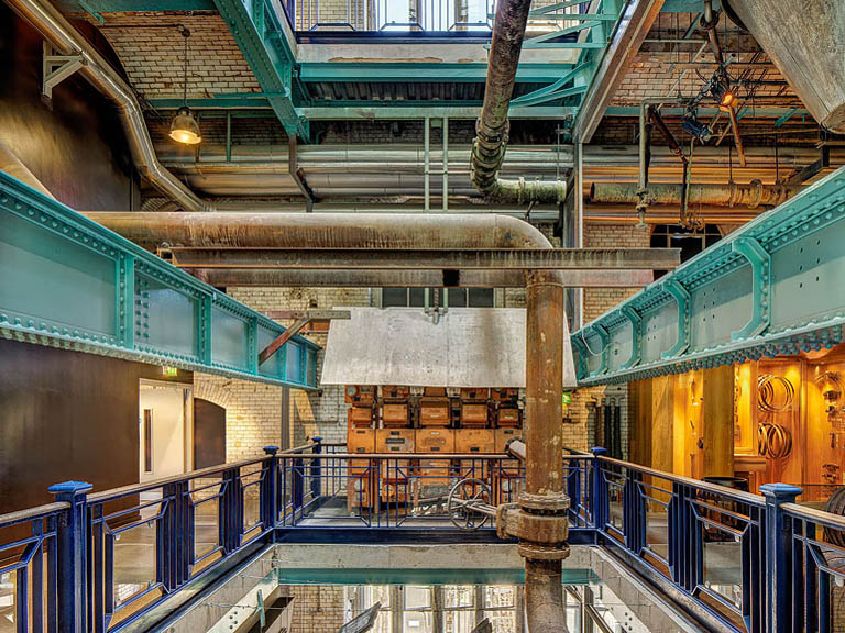 Close up photograph of industrial pipework and valves inside the Guinness Storehouse in Dublin.