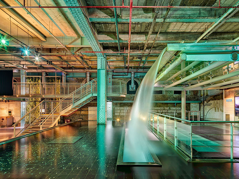 Waterfall feature inside the Guinness Storehouse in Dublin with cascading water framed by industrial structure.