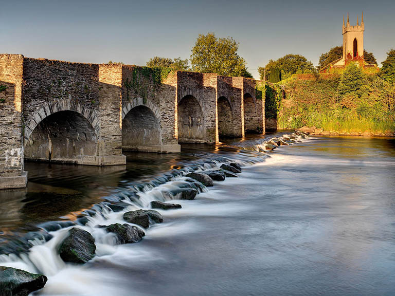 Photograph of Ballycarney Bridge over the River Slaney in County Wexford, with Ballycarney Church beyond