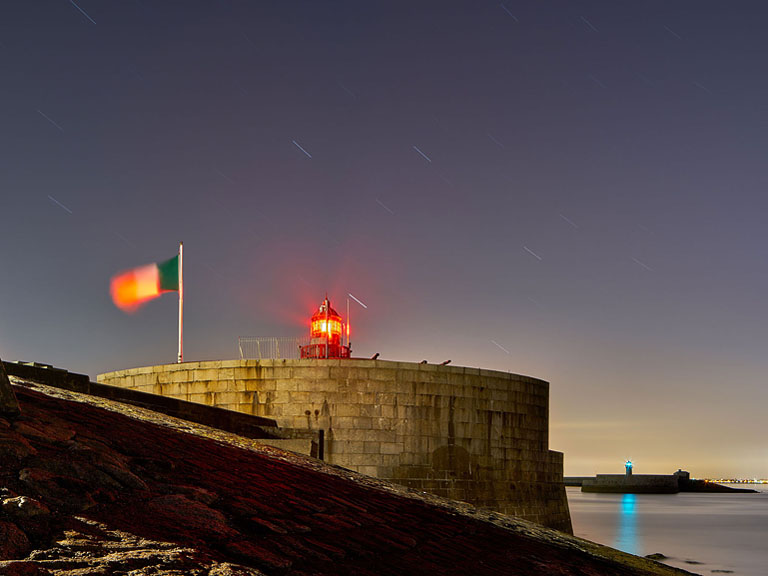 Night photograph of Dun Laoghaire Pier lighthouse under a starry sky, Dublin Bay