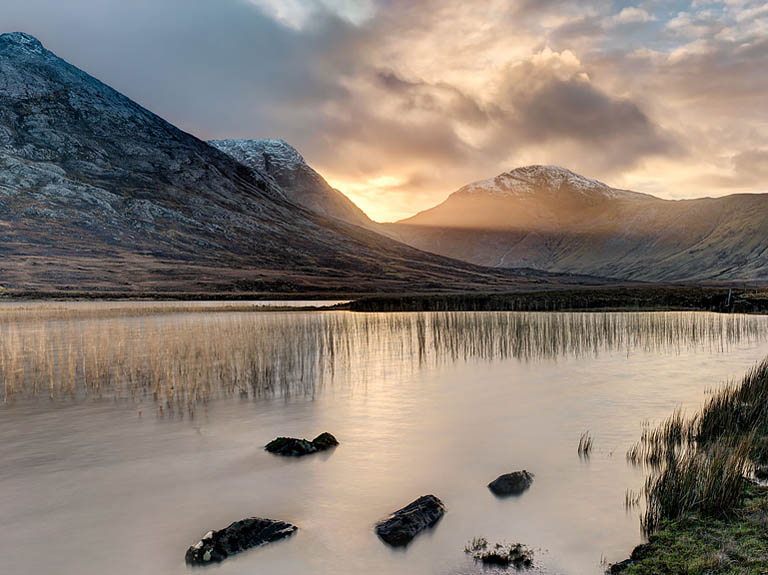 Sunset landscape photograph of Lough Inagh in Connemara, County Galway, with mountains and a break of light in the western sky
