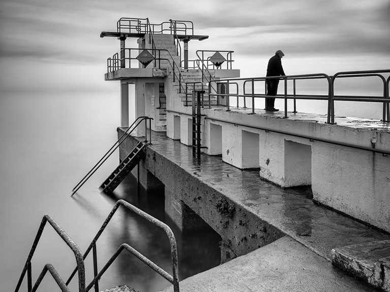 Fine art photograph of Blackrock Diving Tower emerging from mist over Galway Bay
