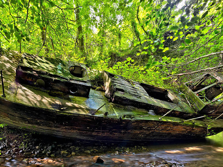 Fine art photograph of an abandoned boat in a woodland stream near Knocksink in County Wicklow