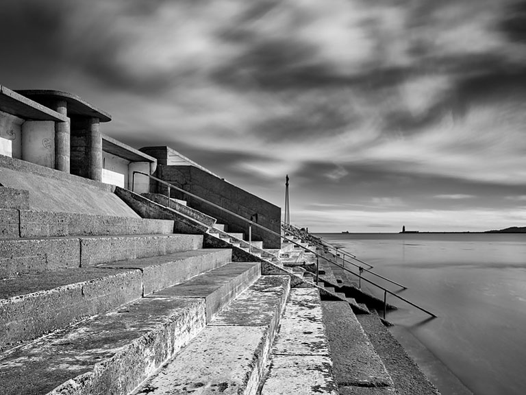 Black and white seascape of the bathing shelter at Bull Island in Dublin, with open water and sky