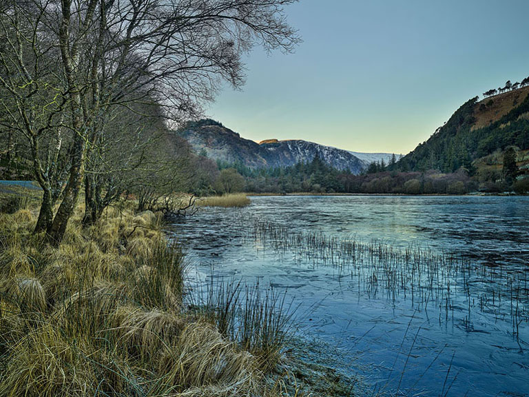Fine art photograph of the frozen Lower Lake at Glendalough in County Wicklow on a cold winter day.