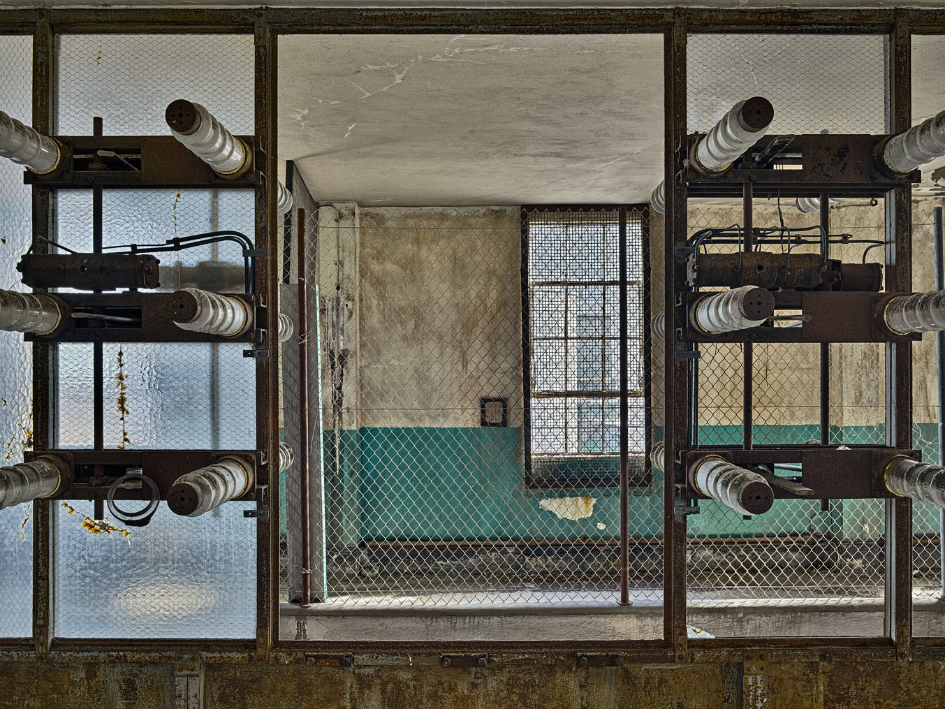 Industrial photograph of old transformers in the Pigeon House Switchgear House in Dublin, inside a decaying power station interior.