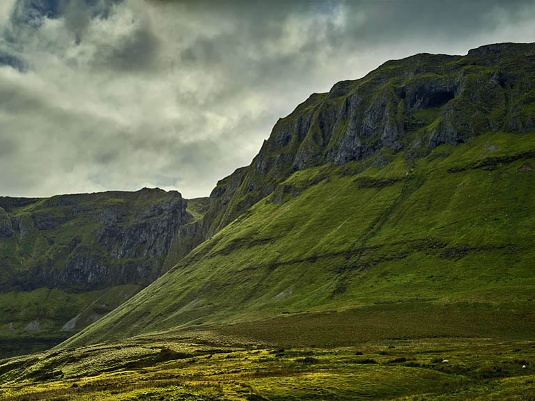 Fine art landscape photograph taken along the Gleniff Horseshoe Drive in County Sligo with fields, cliffs and moody light.