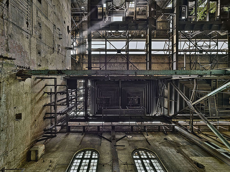 Fine art photograph of the decaying boiler house at Pigeon House Power Station in Dublin, showing bare structural bones and peeling surfaces.