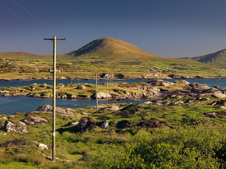 Fine art seascape photograph of weathered poles in the water at Coulagh Bay on the Beara Peninsula in County Cork.