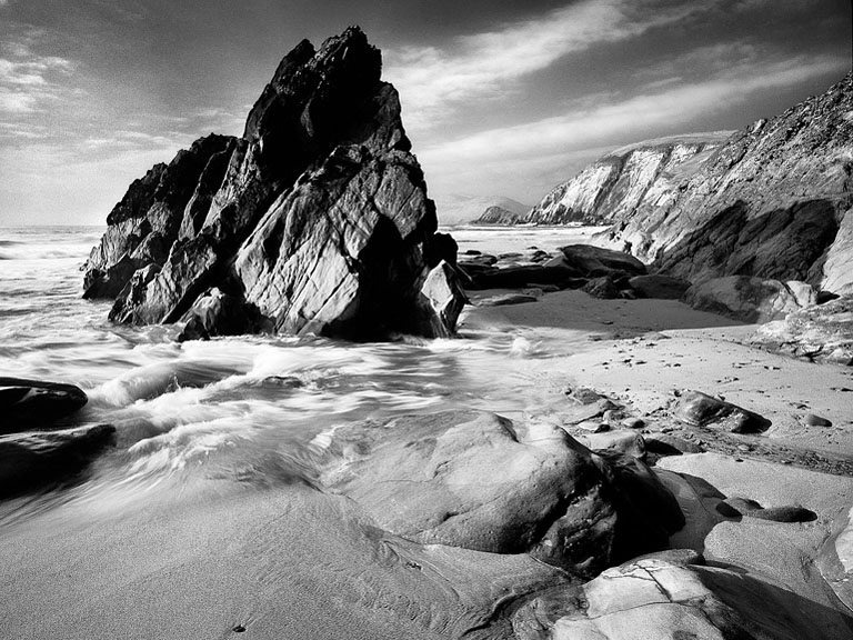 Colour seascape of Coumeenole Beach with cliffs and Atlantic surf on the Dingle Peninsula in County Kerry