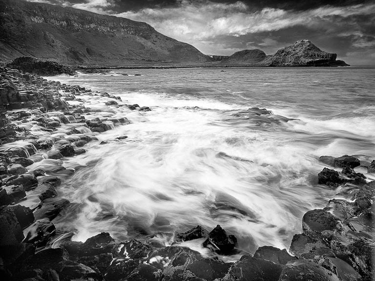 Basalt columns of the Giant's Causeway in County Antrim, showing the geometric rock formations by the sea.