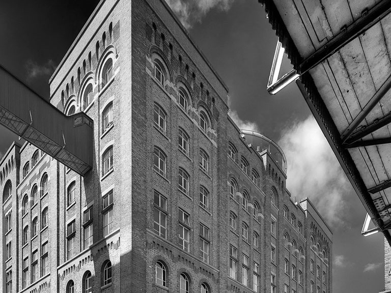 Industrial interior photograph of the Guinness Storehouse at James's Gate, with steel beams and brickwork.