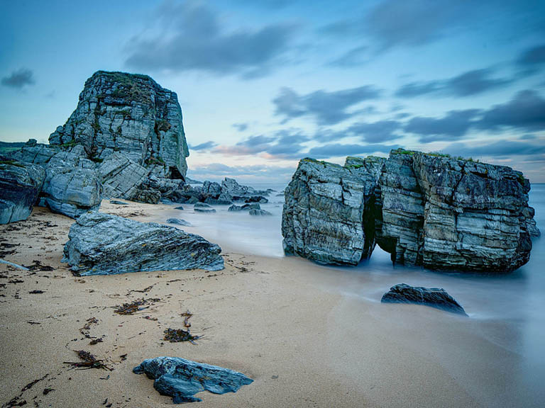 Long exposure seascape photograph of volcanic rock formations at Kinnagoe Bay on the Inishowen Peninsula in County Donegal