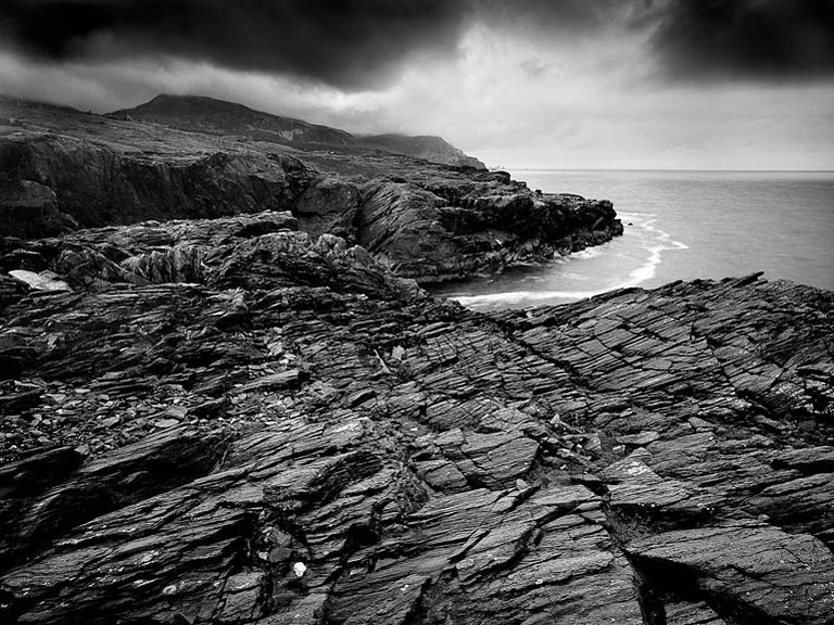 Black and white fine art seascape of Loughros Point in County Donegal, showing jagged rock formations and stormy Atlantic seas
