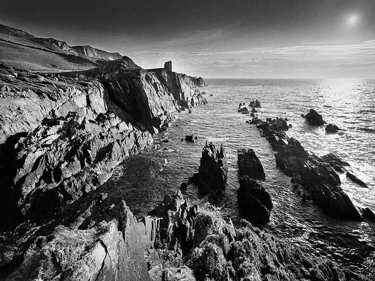 Fine art seascape of O'Driscoll Castle on Cape Clear, with rugged Atlantic cliffs and open sea under a soft, layered sky