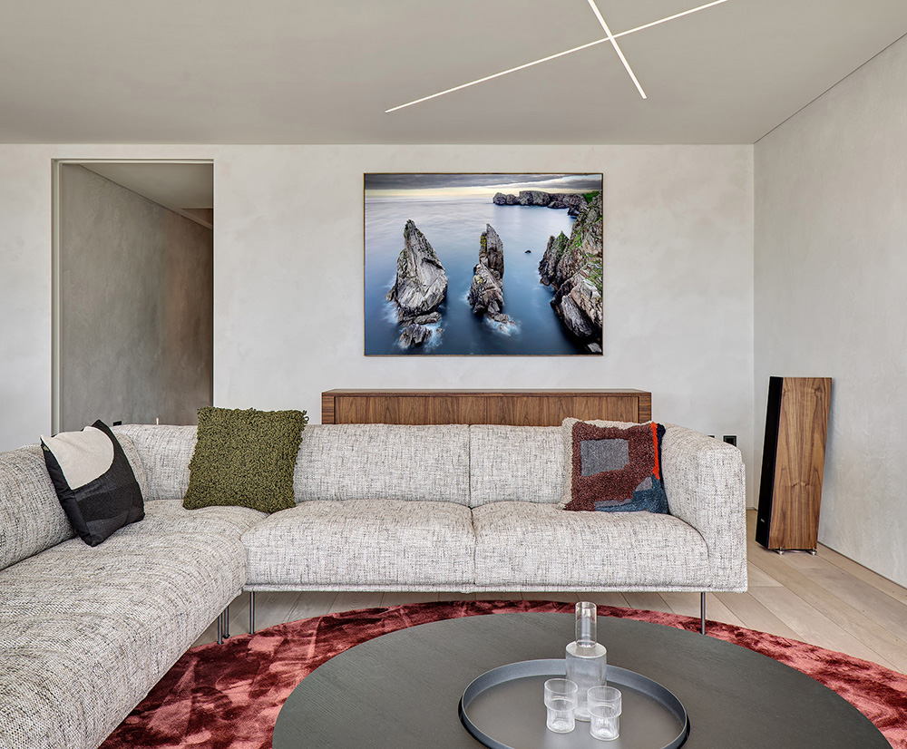 Large coastal landscape print in a contemporary living room